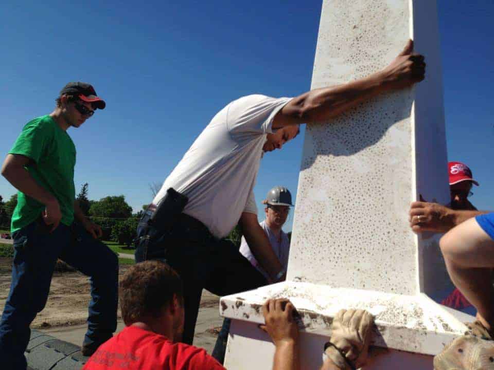 Men installing steeple for new church building