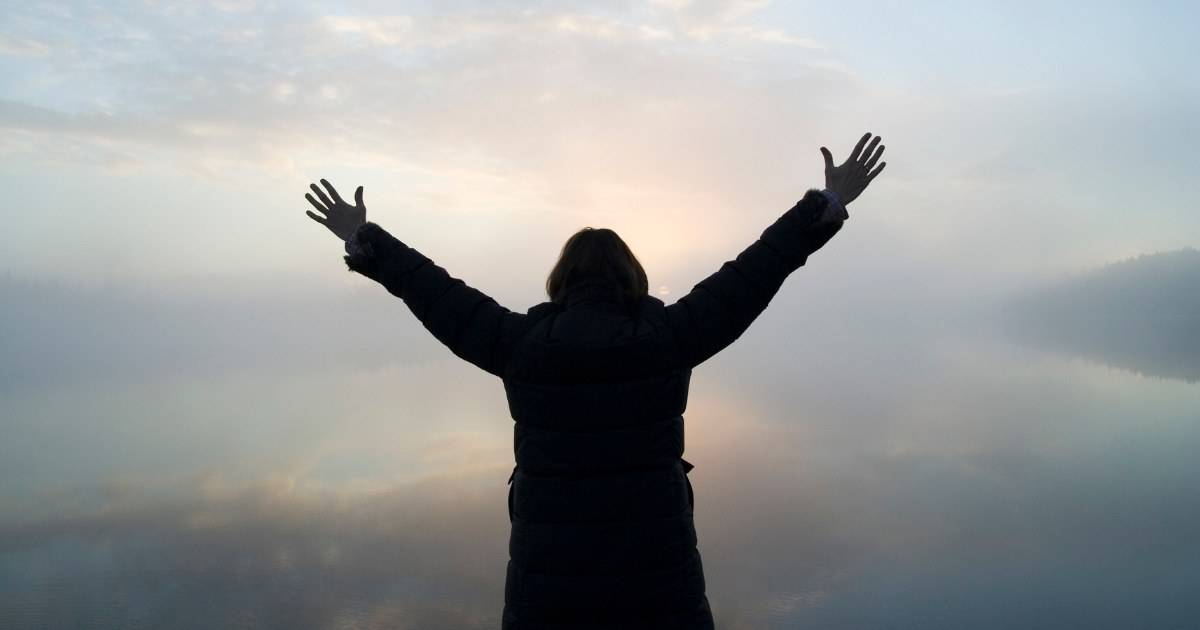 Photo of woman lifting hands to worship