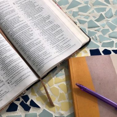 Bible and notebook on table