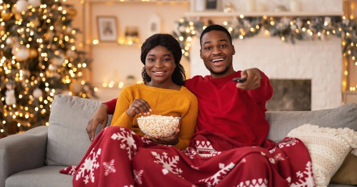 Couple watching movies from the best Christian Christmas movies list